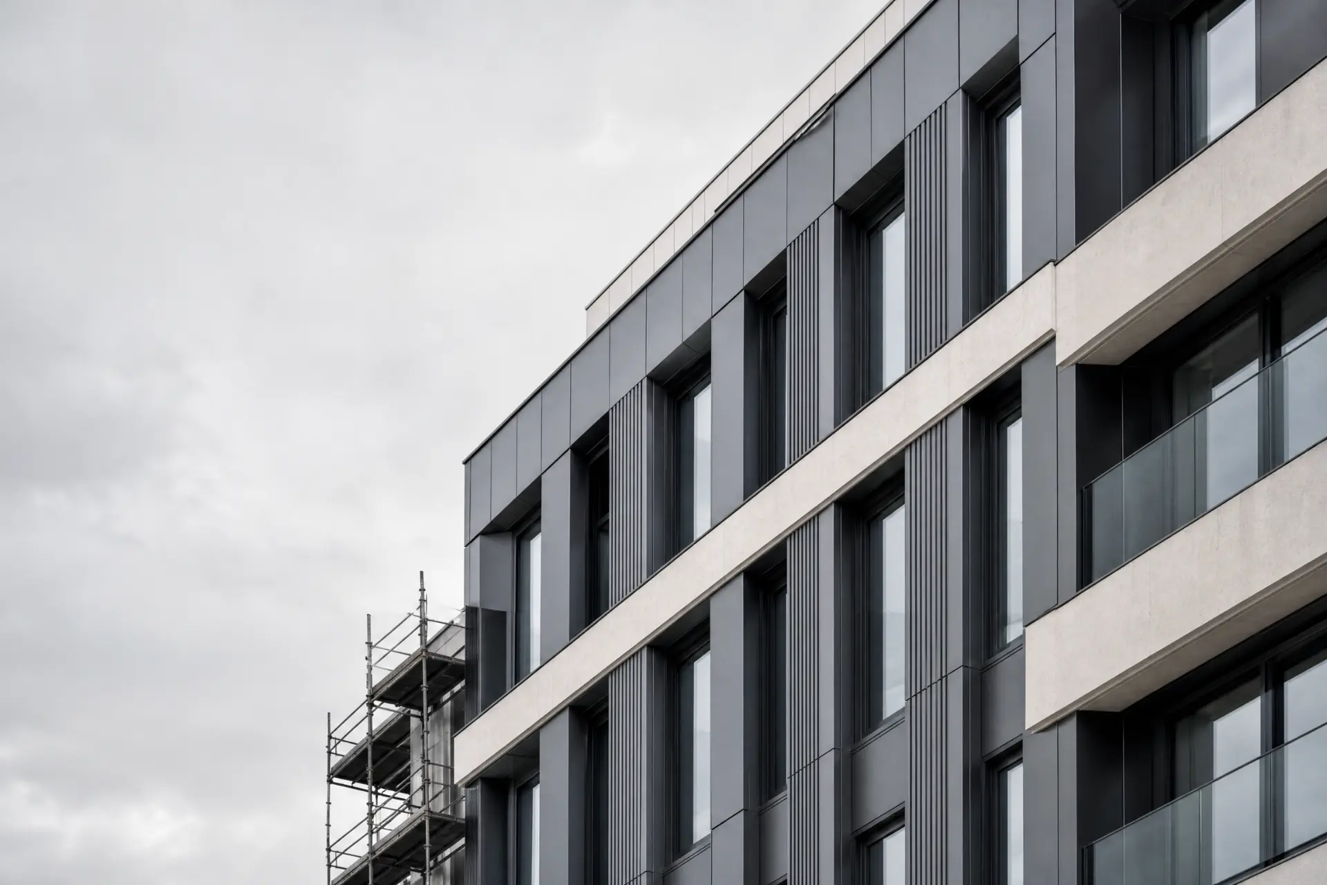 Clad residential façade under remediation with scaffolding to one elevation